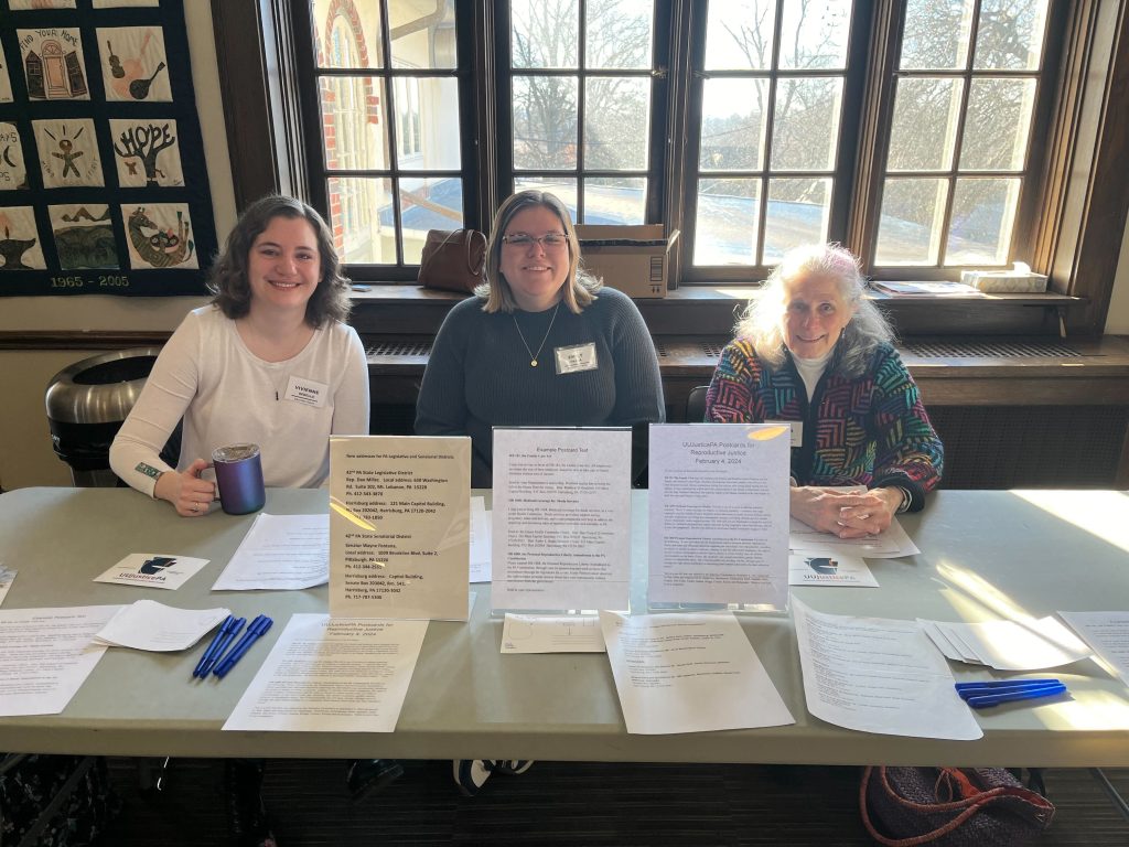 Vivienne, Emily, and Dallas at a tabling event